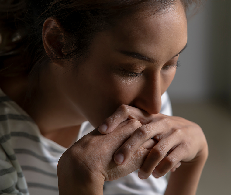 Person feeling anxious or overwhelmed by cancer