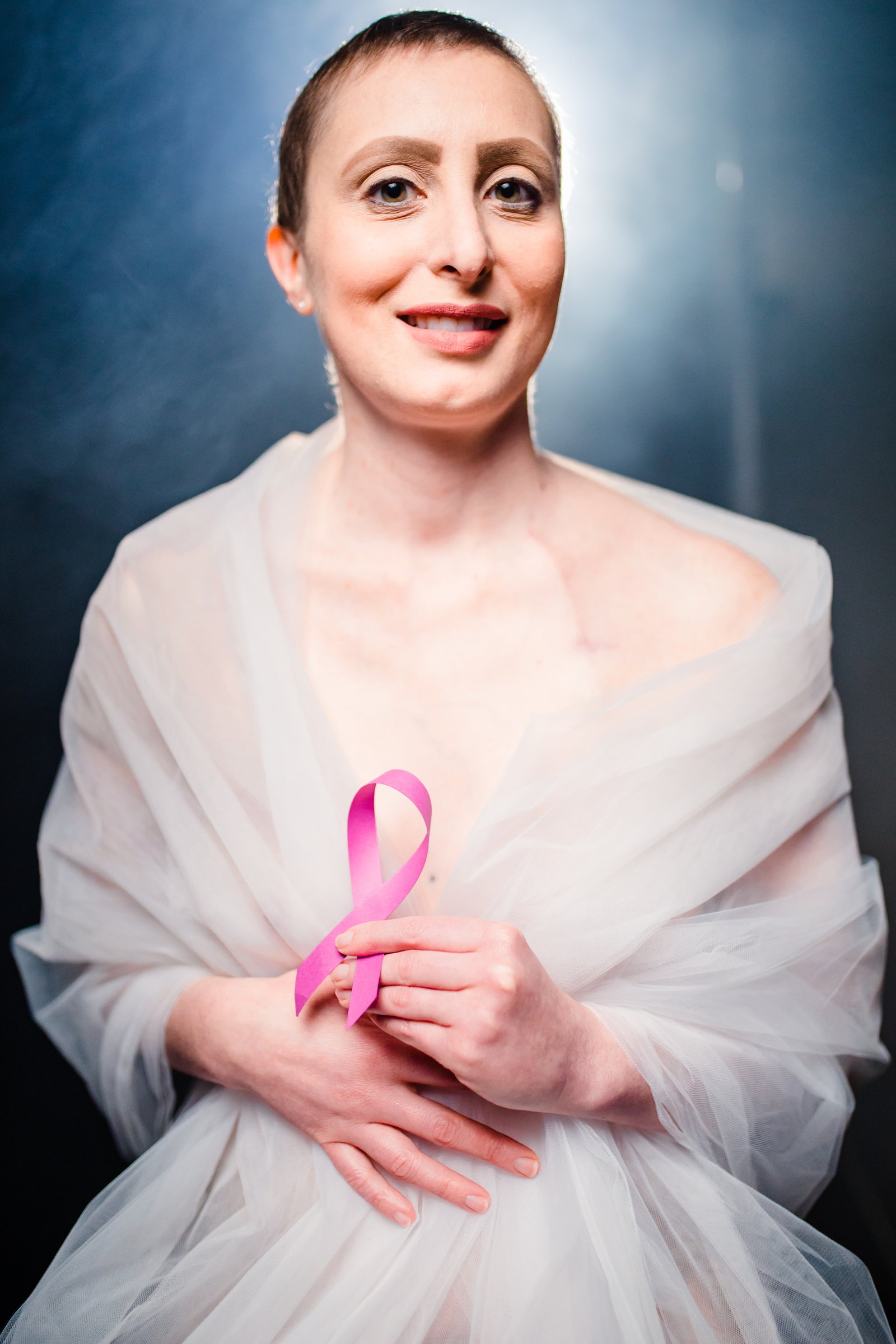 Person holding a cancer awareness ribbon